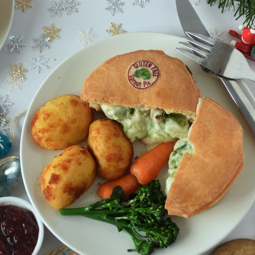 Gluten-free SPROUT PIE with sides on a plate with Christmas decorations in the background